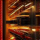 Warm LED accent lighting highlighting bottles on wine racking.